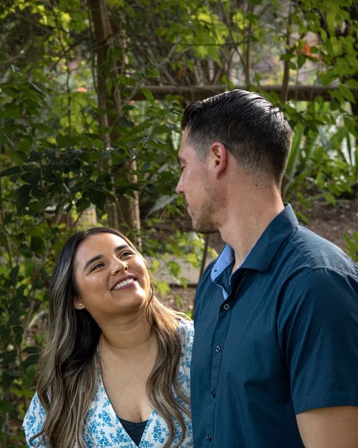 Couple smiling at each other outdoors