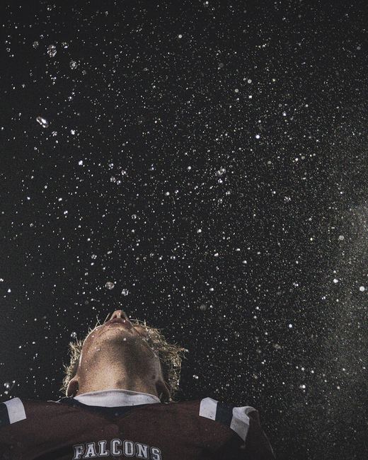 Football player under falling rain