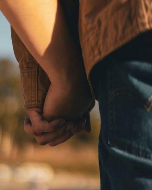 Couple holding hands close up