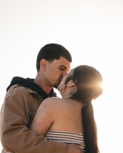 Couple kissing in golden sunlight