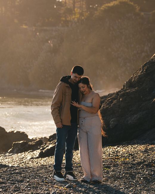 Couple embracing on a rocky beach