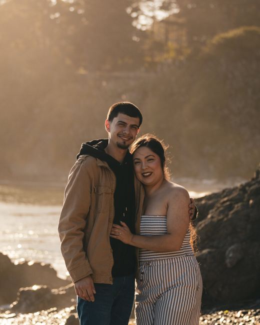 Engaged couple smiling at camera
