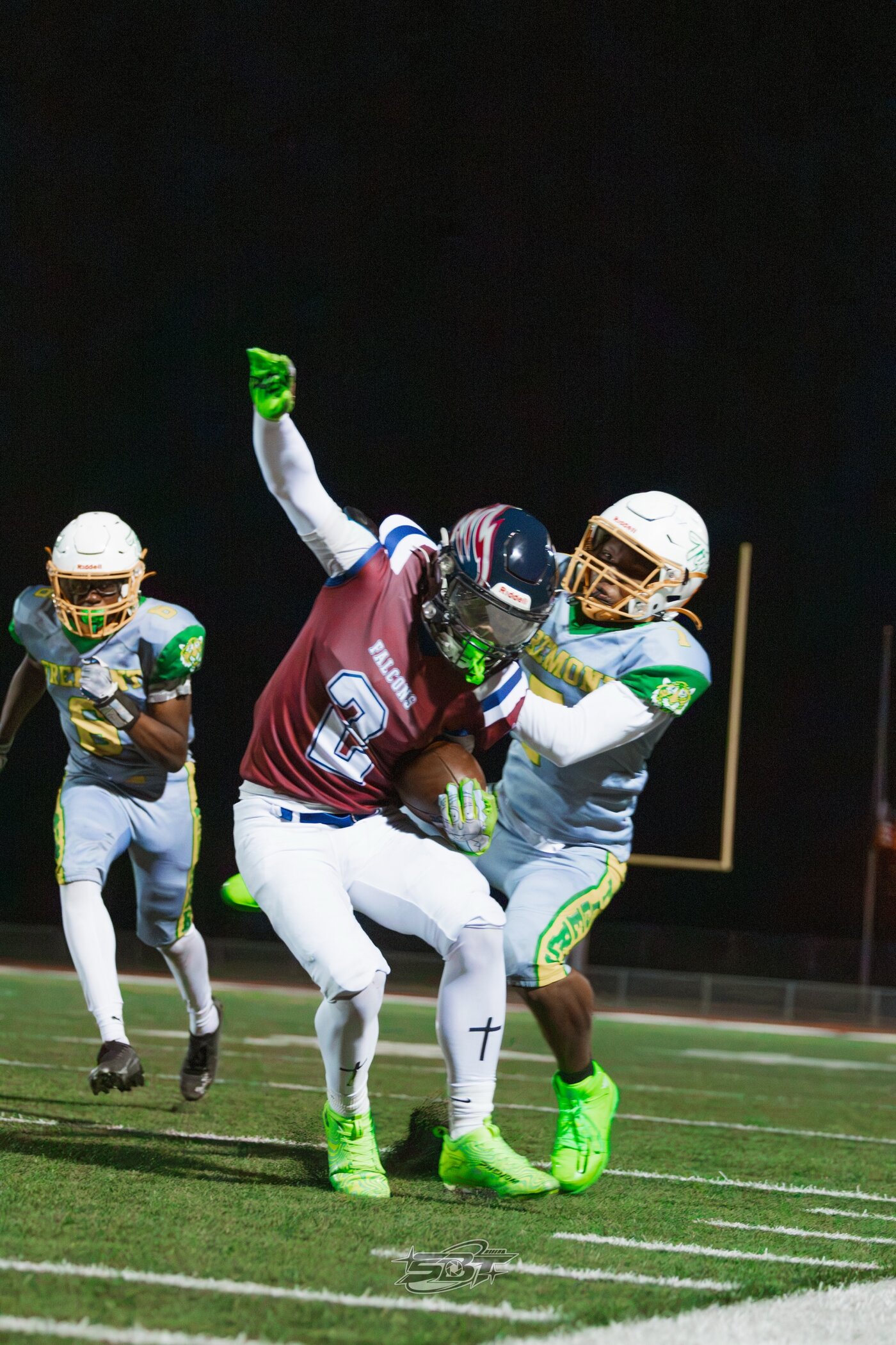 Multiple defenders making a night tackle