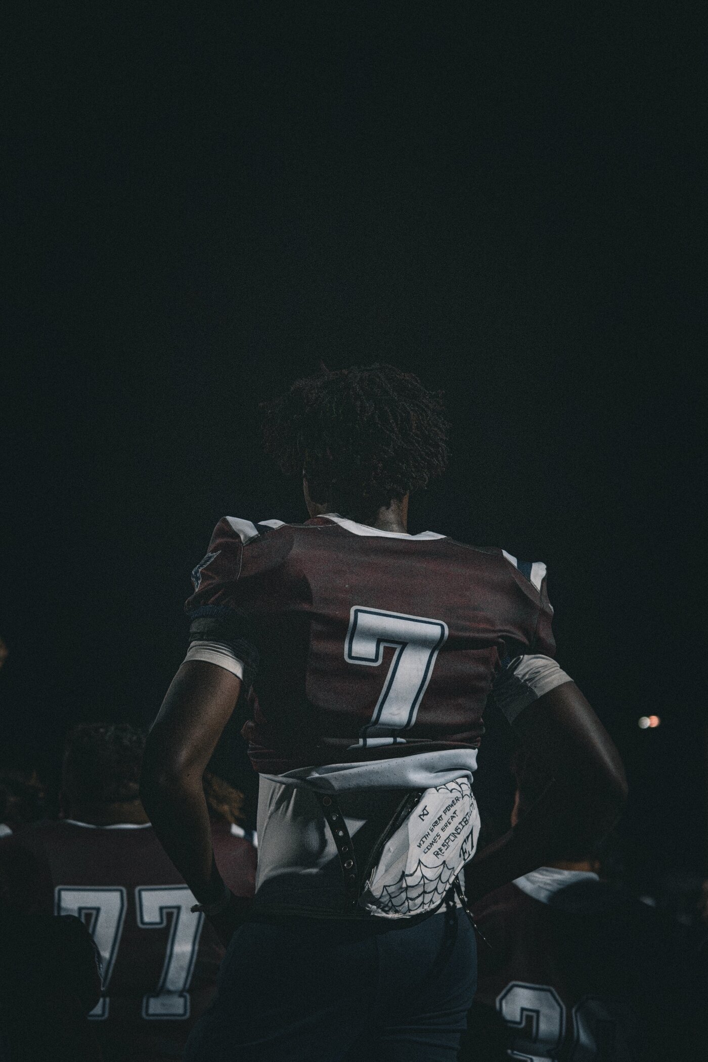 Player from behind with a handwritten quote on his pads