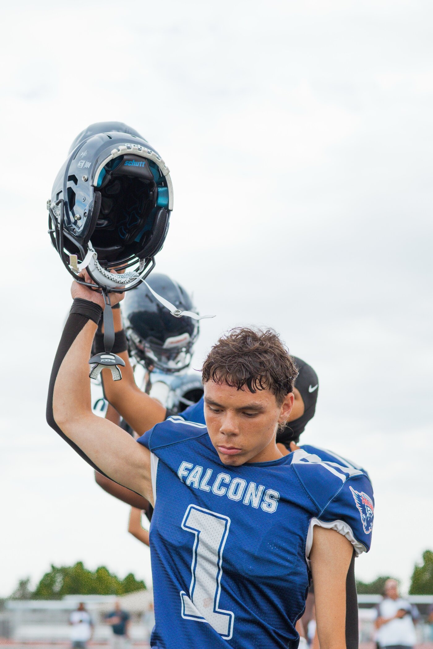 Player holding up his helmet