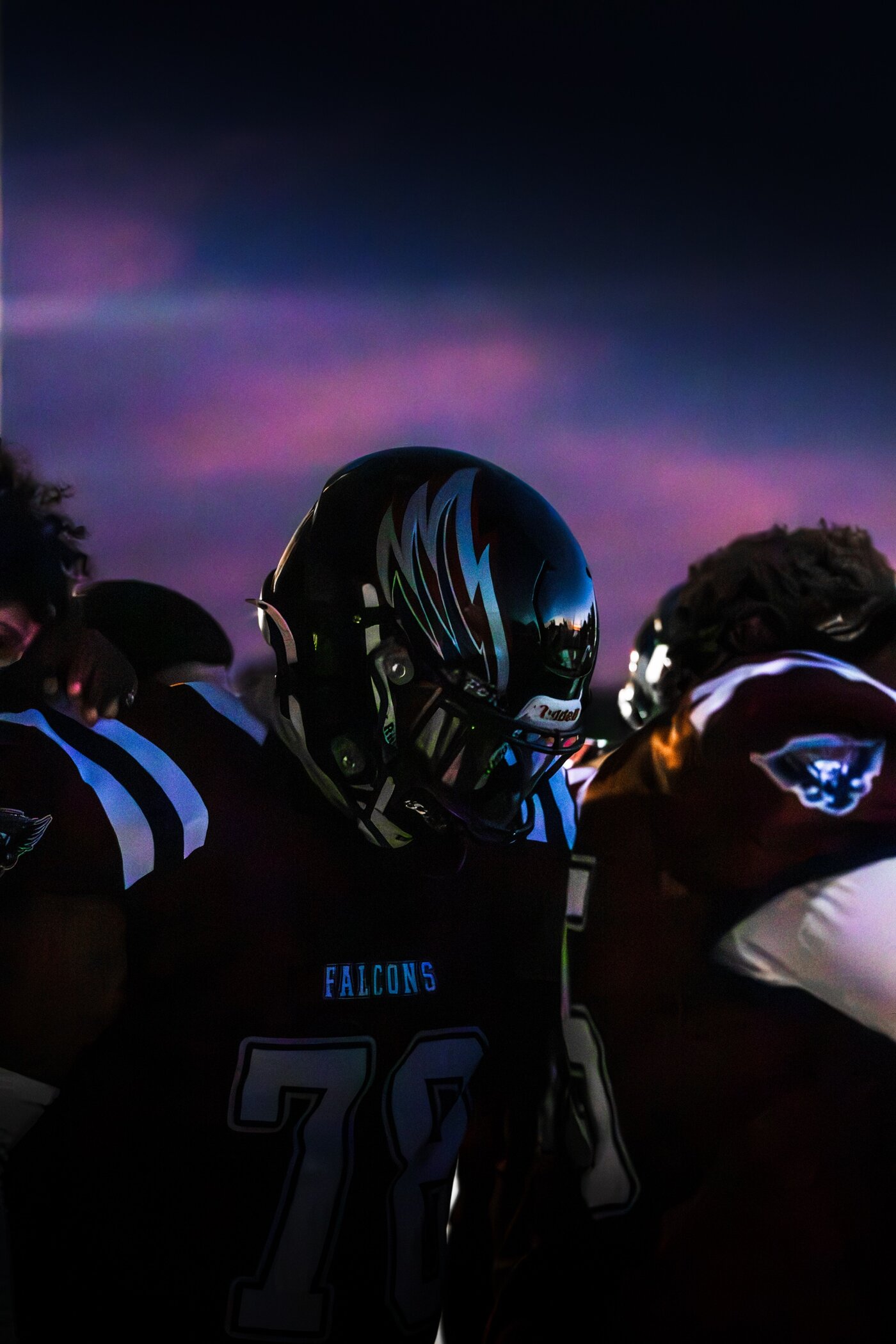 Player silhouetted against a purple sunset sky
