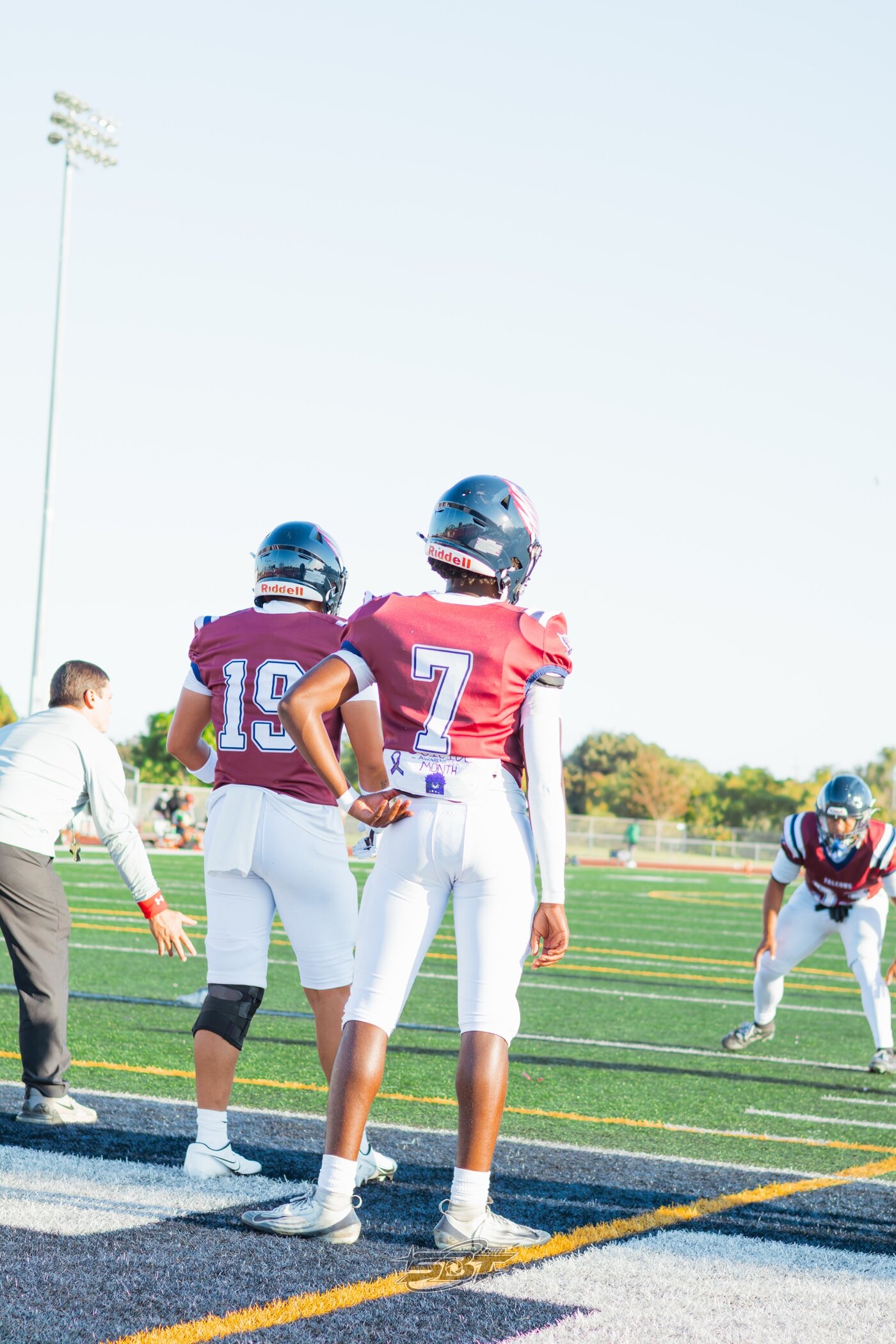 Two players standing ready on the sideline