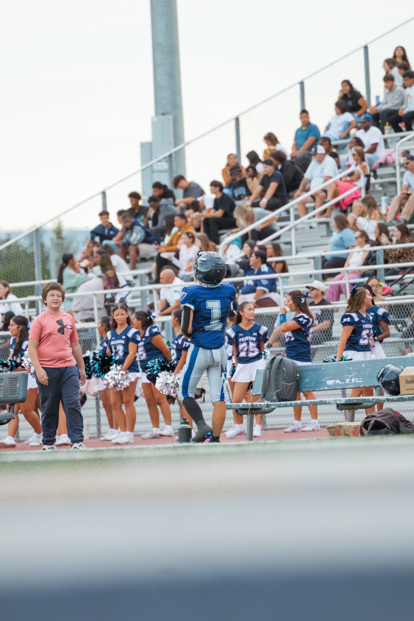 Player walking the sideline past the crowd