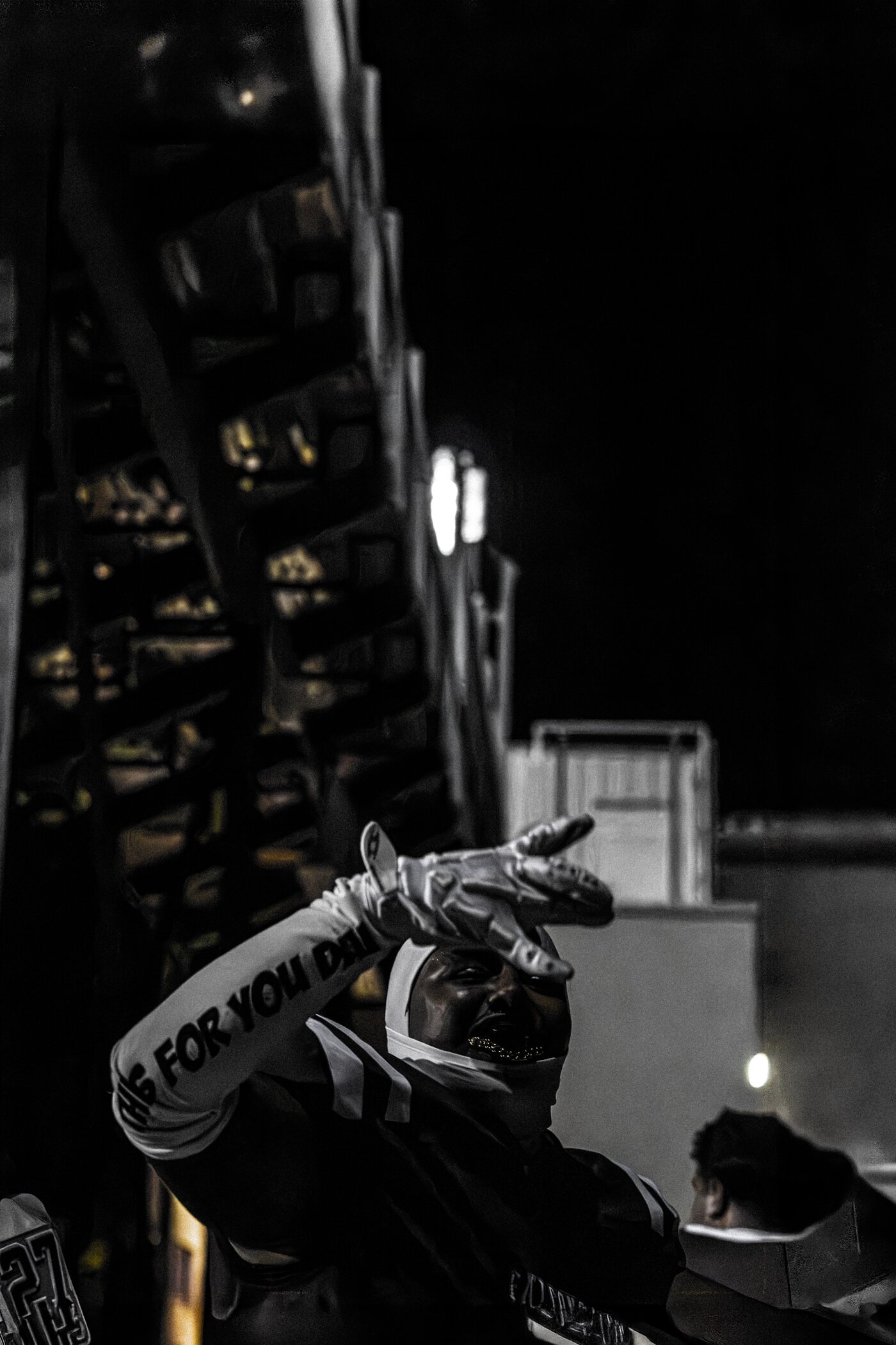 Player making a hand gesture in dramatic lighting