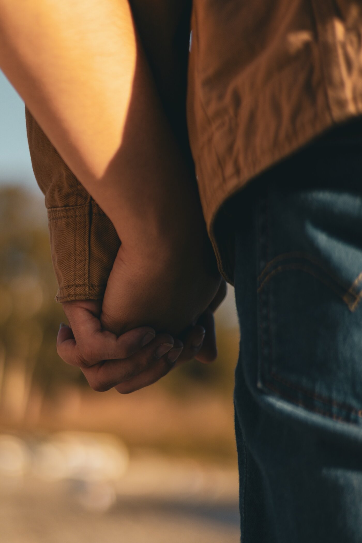 Couple holding hands close up