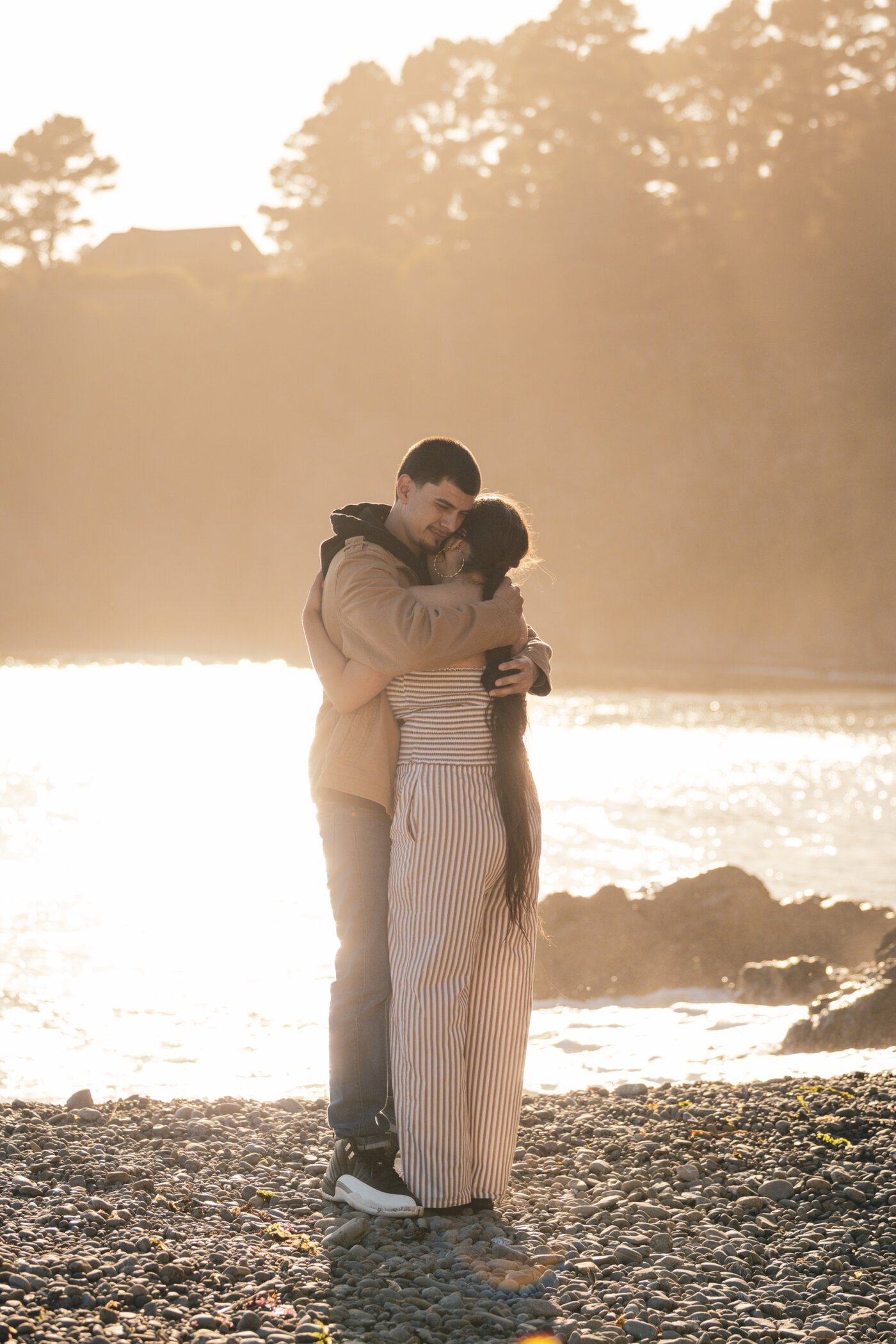 Backlit couple embracing at sunset