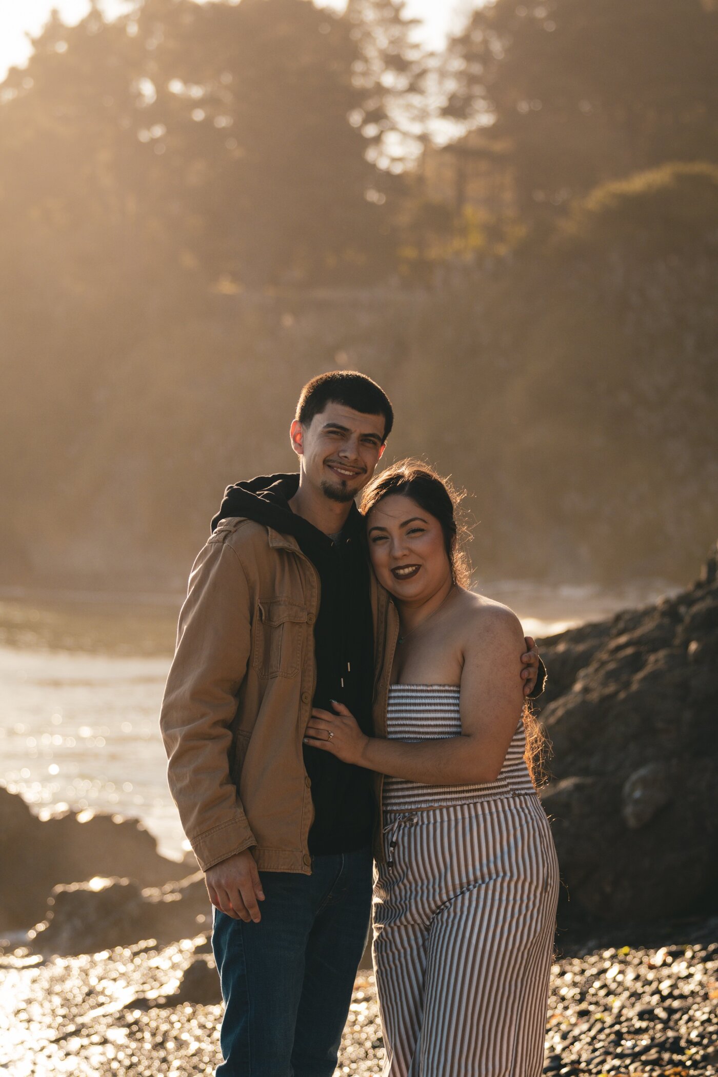 Engaged couple smiling at camera