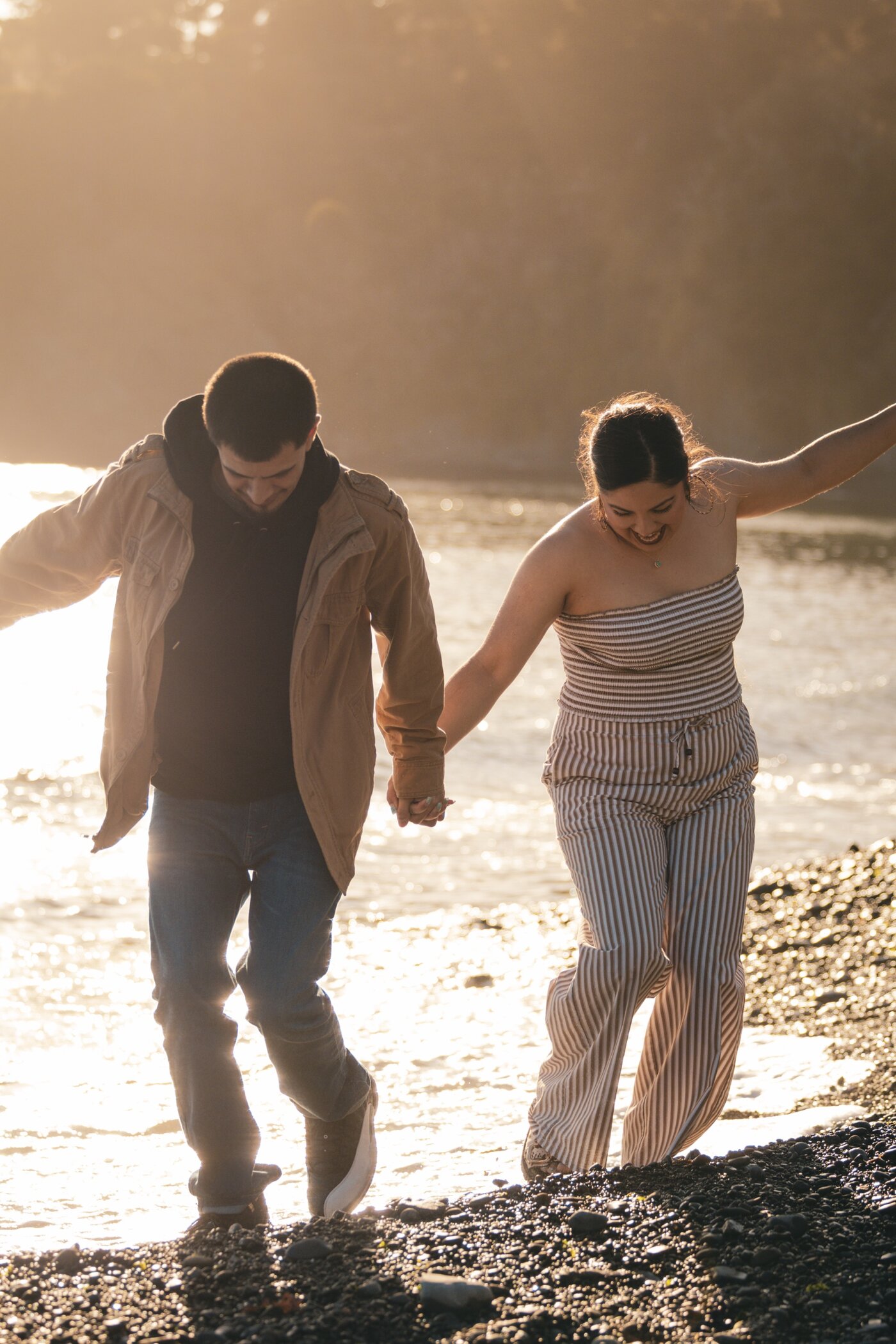 Couple walking the shoreline hand in hand
